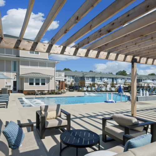 Pool area with loungers at Attain at Bradford Creek Huntsville, Alabama apartments. Pool area with loungers at Attain at Bradford Creek Huntsville, Alabama apartments.