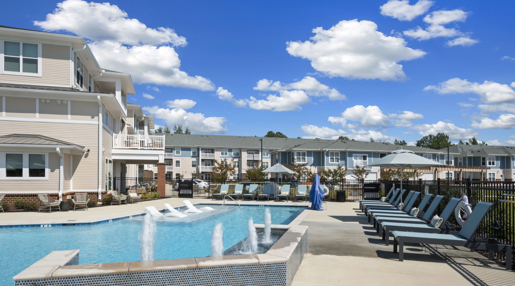 View of the resort-style pool with the backdrop of Attain at Bradford Creek apartments for rent in Huntsville, AL. View of the resort-style pool with the backdrop of Attain at Bradford Creek apartments for rent in Huntsville, AL.